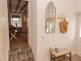 A hallway with a mirror and bench at Penwyn in Solva
