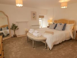 A bedroom with a bed and a mirror at Penwyn in Solva