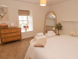 A bedroom with a bed and mirror at Penwyn in Solva
