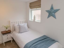 A bedroom with a bed and side table at Penwyn in Solva