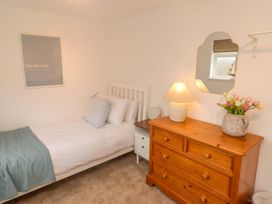 A bedroom with a single bed and wooden dresser at Penwyn in Solva