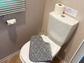 A bathroom with a toilet and toilet paper at Seren in Broughton, Cumbria