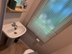 A bathroom with a washbasin and toilet at Seren, Broughton, Cumbria