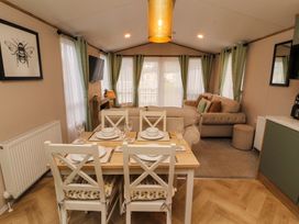 A dining room with a table and chairs at Seren in Broughton, Cumbria