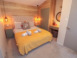 A bedroom with a bed and bedside tables at Seren in Broughton, Cumbria
