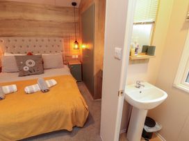 A bedroom with a bed and a sink at Seren in Broughton, Cumbria