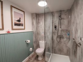 A bathroom with a toilet and a glass-enclosed shower at Flat 2 The Old Chapel in Whitby