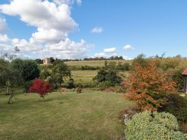 A garden with trees and a horse in a field at 32 Castlegate Scarborough