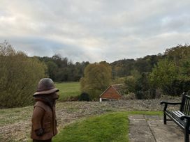 A wooden sculpture and a bench near a field at 32 Castlegate East Ayton