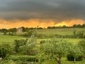 A landscape with ruins and cattle in the fields at 32 Castlegate East Ayton