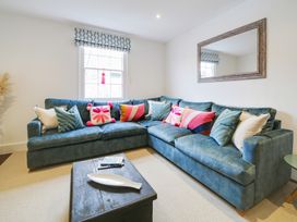 A living room with a couch and coffee table at Church Hill House Port Isaac