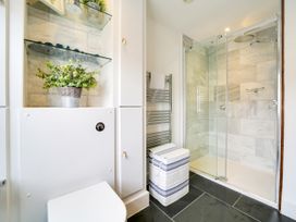 A bathroom with a shower and toilet at Church Hill House Port Isaac