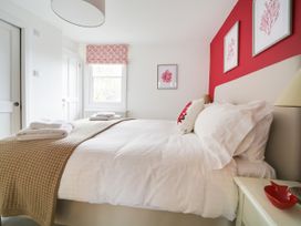 A bedroom with a bed and decorative elements at Church Hill House in Port Isaac