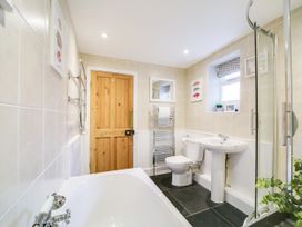 A bathroom with a bathtub and a sink at Church Hill House, Port Isaac