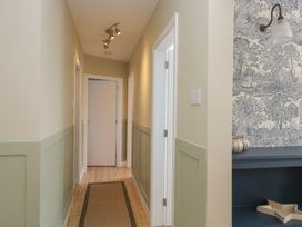 A hallway with light fixtures and decorative wallpaper at The Barn at Grasmere