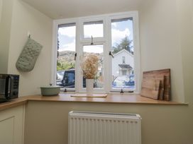 A kitchen with a vase on a windowsill at The Barn at Grasmere