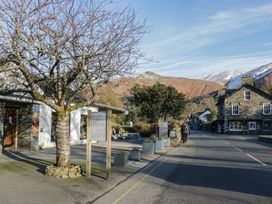 A street with a building and a tree at The Barn at Grasmere in Grasmere