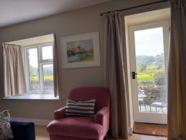 A living room with a view of a garden at The Barn at Grasmere in Grasmere