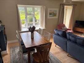 A living room with a table and chairs by a window at The Barn at Grasmere in Grasmere