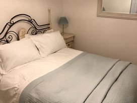 A bedroom with a bed and lamp at Pen Y Ffrith Lodge in Prestatyn
