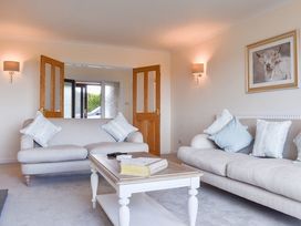 A living room with a sofa and coffee table at Cae Coch in Brynteg near Benllech