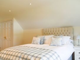 A bedroom with a bed and bedside table at Cae Coch in Brynteg near Benllech