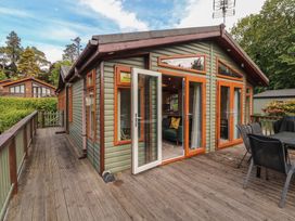 An outdoor patio area with a green cabin at 28 Troutbeck in Bassenthwaite