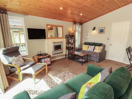 A living room with a sofa and fireplace at 28 Troutbeck in Bassenthwaite