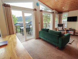 A living room with a sofa and television at 28 Troutbeck in Bassenthwaite