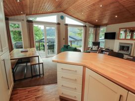A living room with a dining table and sofa at 28 Troutbeck in Bassenthwaite