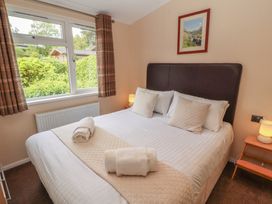A bedroom with a double bed and a window at 28 Troutbeck in Bassenthwaite