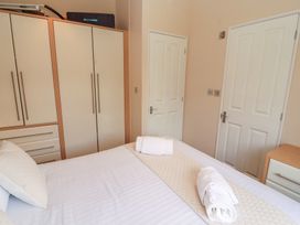 A bedroom with a bed and wardrobe at 28 Troutbeck in Bassenthwaite
