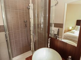 A bathroom with a shower and sink at 28 Troutbeck in Bassenthwaite