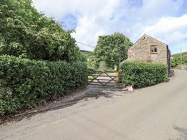 A gate leading to a property with hedges on either side at Chapel Cottage in Ennerdale near Cleator Moor