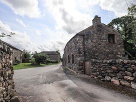 An outdoor view of stone buildings with a road in Ennerdale near Cleator Moor