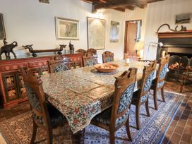 A dining room with a wooden table and chairs at Chapel Cottage Ennerdale near Cleator Moor