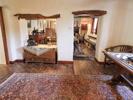 A dining room with a wooden table and chairs at Chapel Cottage Ennerdale near Cleator Moor