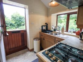 A kitchen with a sink and stove at Chapel Cottage in Ennerdale near Cleator Moor