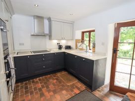 A kitchen with cabinets and a sink at Chapel Cottage in Ennerdale near Cleator Moor