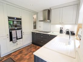 A kitchen with cabinets and appliances at Chapel Cottage in Ennerdale near Cleator Moor