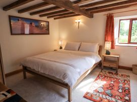 A bedroom with a bed and nightstands at Chapel Cottage Ennerdale near Cleator Moor
