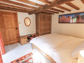 A bedroom with a bed and wardrobe at Chapel Cottage Ennerdale near Cleator Moor