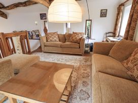 A living room with a sofa and coffee table at Chapel Cottage in Ennerdale near Cleator Moor