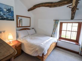 A bedroom with a bed and a window at Chapel Cottage in Ennerdale near Cleator Moor