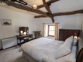 A bedroom with a bed and furniture at Chapel Cottage in Ennerdale near Cleator Moor