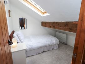 A bedroom with a bed and nightstand at Chapel Cottage Ennerdale near Cleator Moor