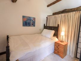 A bedroom with a bed and bedside table at Chapel Cottage in Ennerdale near Cleator Moor