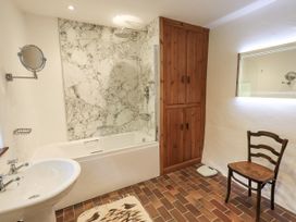 A bathroom with a bathtub and shower at Chapel Cottage in Ennerdale near Cleator Moor