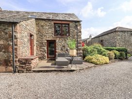 An outdoor seating area near a stone building at Chapel Cottage in Ennerdale near Cleator Moor