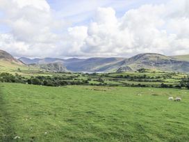 A green field with sheep and mountains in the background at Chapel Cottage in Ennerdale near Cleator Moor